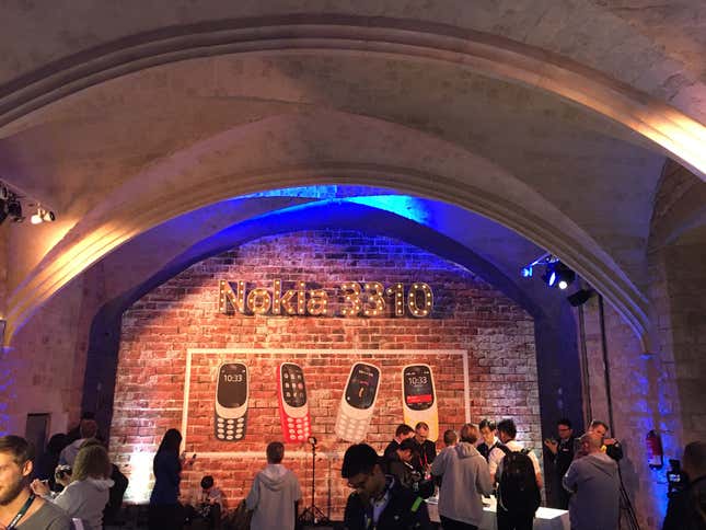 Members of the media crowd around the Nokia 3310 phones at the showcase.