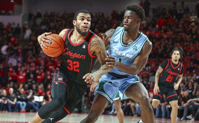 Feb 22, 2023; Houston, Texas, USA; Houston Cougars forward Reggie Chaney (32) drives with the ball as Tulane Green Wave guard Sion James (1) defends during the second half at Fertitta Center.