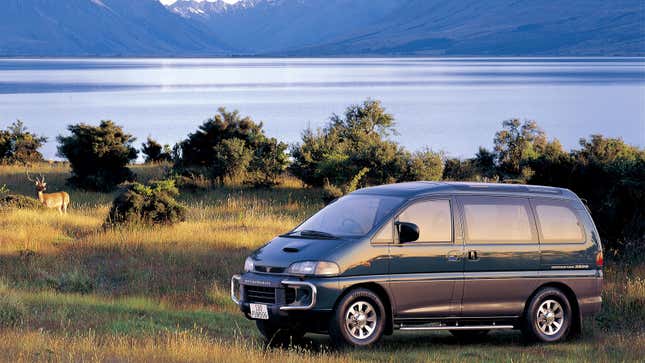 A photo of a 1996 Mitsubishi Delica parked by a lake. 