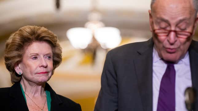 Senator Debbie Stabenow stares at Sen. Chuck Schumer on Capitol Hill.