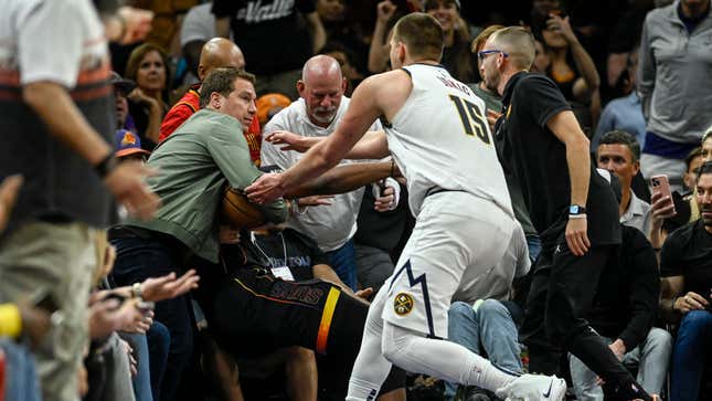 Nikola Jokic doing his best to retrieve the ball from a man-child who thinks he’s part of the game. 