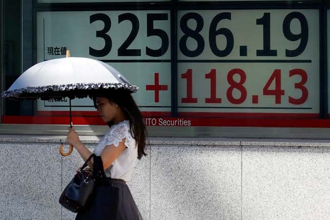 A person walks in front of an electronic stock board showing Japan&#39;s Nikkei 225 index at a securities firm Tuesday, Sept. 12, 2023, in Tokyo. Asian shares mostly declined Tuesday despite a Big Tech rally on Wall Street, as investors looked ahead to data on U.S. consumer prices set for later in the week. (AP Photo/Eugene Hoshiko)