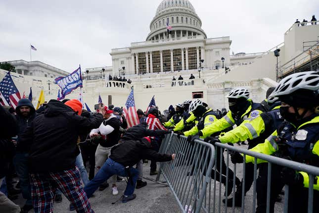 In this Jan. 6, 2021 file photo, supporters loyal to then-President Donald Trump, try to break through a police barrier at the Capitol in Washington.