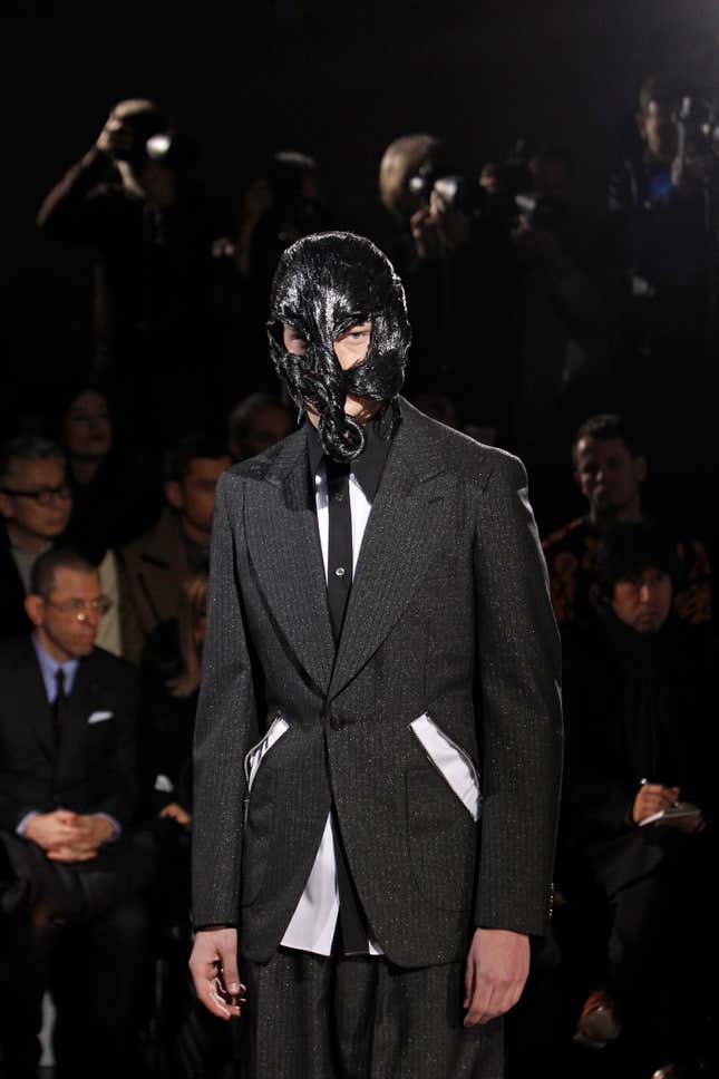 A model presents a creation as part of Comme Des Garcons men's Fall-Winter 2014-2015 fashion collection, presented Friday, Jan. 17, 2014 in Paris. (AP Photo/Thibault Camus)