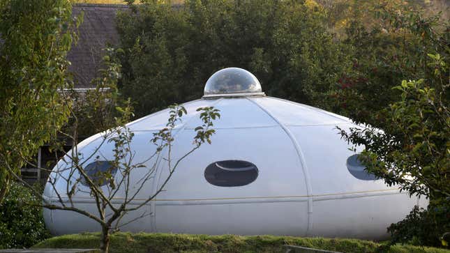 The camping accommodation shaped like a flying saucer is surrounded by the Welsh woods