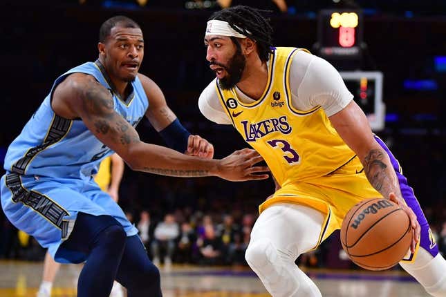 Mar 7, 2023; Los Angeles, California, USA; Los Angeles Lakers forward Anthony Davis (3) moves the ball against Memphis Grizzlies forward Xavier Tillman (2) during the first half at Crypto.com Arena.