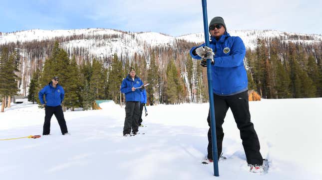 Department of Water Resources employees measure snow depth at Phillips Station in the Sierra Nevada Mountains on Feb 1, 2023