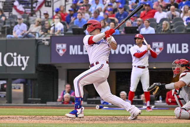 Apr 1, 2023; Arlington, Texas, USA; Texas Rangers catcher Mitch Garver (18) hits a three run home run against the Philadelphia Phillies during the fifth inning at Globe Life Field.