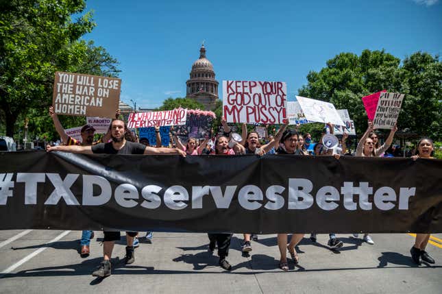 AUSTIN, TX - MAY 29: Pro choice protesters march down Congress Avenue at a protest outside the Texas state capitol on May 29, 2021 in Austin, Texas. Thousands of protesters came out in response to a new bill outlawing abortions after a fetal heartbeat is detected signed on Wednesday by Texas Governor Greg Abbot. (Photo by Sergio Flores/Getty Images)