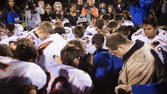 Football coach Joe Kennedy leading a prayer circle on October 16, 2015.