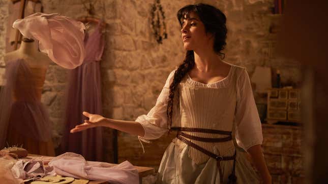 Camila Cabello strikes a pose in a dressmaking scene in the new musical Cinderella.