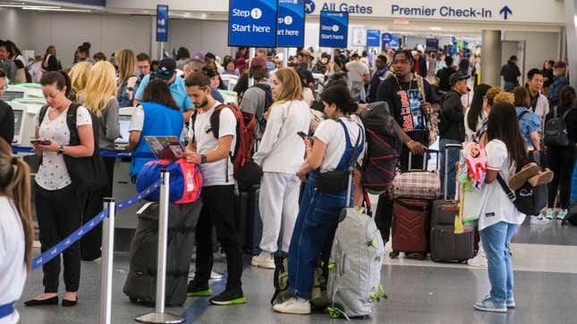 crowd of people waiting in line for united airlines flight