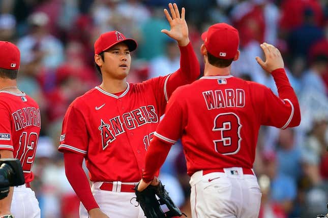 Jul 19, 2023; Anaheim, California, USA; Los Angeles Angels designated hitter Shohei Ohtani (17) and left fielder Taylor Ward (3) celebrate the victory against the New York Yankees at Angel Stadium.