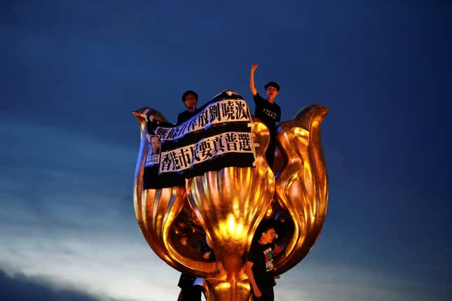 Hong Kong democracy activists protest Xi Jinping’s visit.