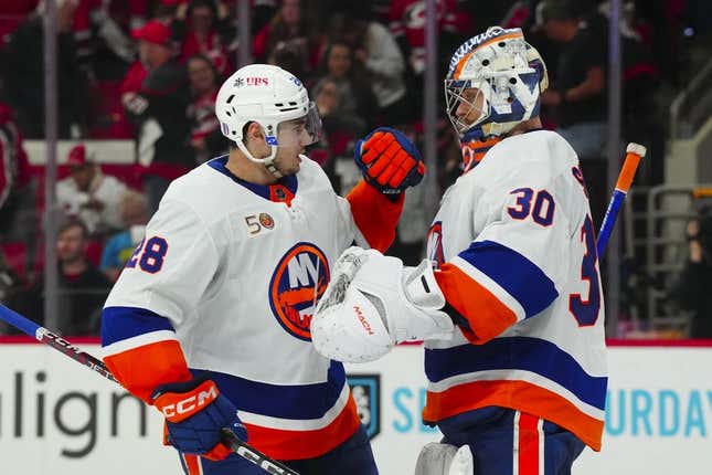 Apr 25, 2023; Raleigh, North Carolina, USA; New York Islanders goaltender Ilya Sorokin (30) and defenseman Alexander Romanov (28) celebrate their victory against the Carolina Hurricanes in game five of the first round of the 2023 Stanley Cup Playoffs at PNC Arena.