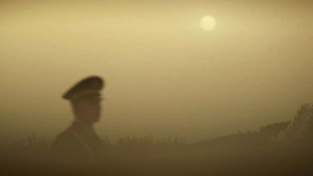 A police officer patrols Tiananmen Square during a dust storm on April 18, 2006 in Beijing, China. 