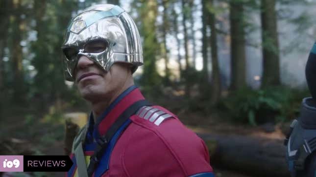 John Cena as Peacemaker, smirking and standing in a forest, in HBO Max's Peacemaker. 