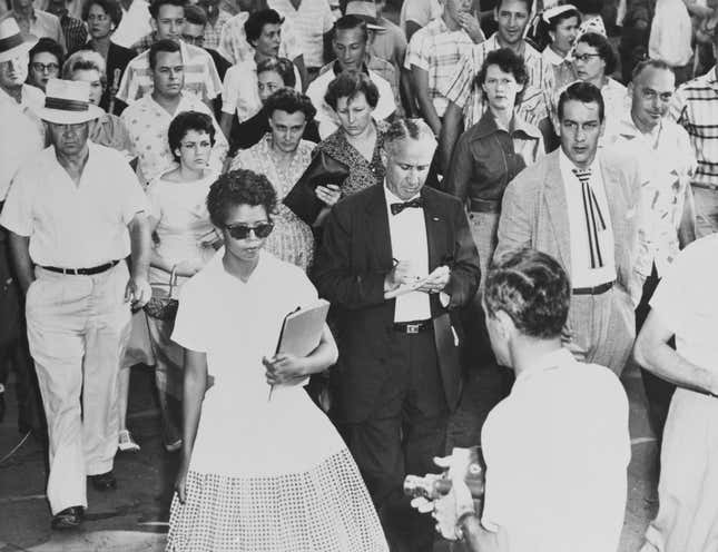 15-year-old Elizabeth Eckford is followed by a sullen mob as she attends her first day at Little Rock Central High School in Little Rock, Arkansas, 4th September 1957