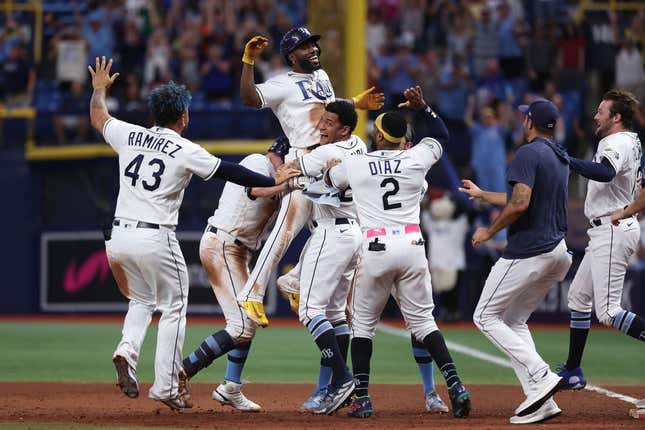 Aug 12, 2023; St. Petersburg, Florida, USA;  Tampa Bay Rays left fielder Randy Arozarena (56) is congratulated after he hit a walk off RBI single against the Cleveland Guardians during the ninth inning at Tropicana Field.