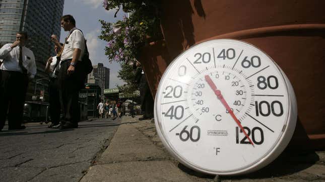 A thermometer in the sun on the sidewalk indicates a temperature of 120 degrees Fahrenheit as people eat ice cream on the Upper West Side August 2, 2006 