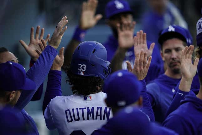 Apr 29, 2023; Los Angeles, California, USA; Los Angeles Dodgers center fielder James Outman (33) is greeted by teammates after scoring a run against the St. Louis Cardinals during the second inning at Dodger Stadium.