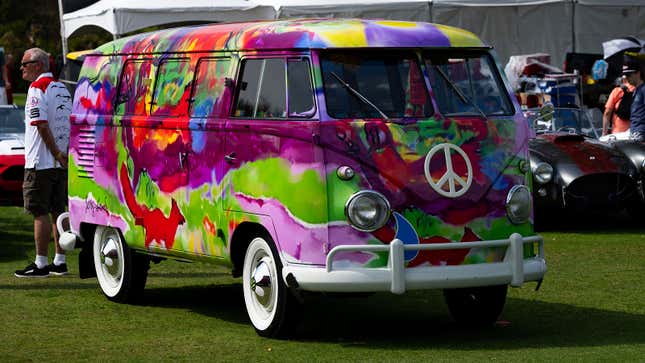 A photo of a multi-colored VW Transporter bus. 