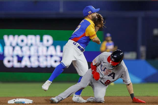 Mar 18, 2023; Miami, Florida, USA; Venezuela second baseman Jose Altuve (27) turns a double play over USA shortstop Trea Turner (8) during the second inning at LoanDepot Park.