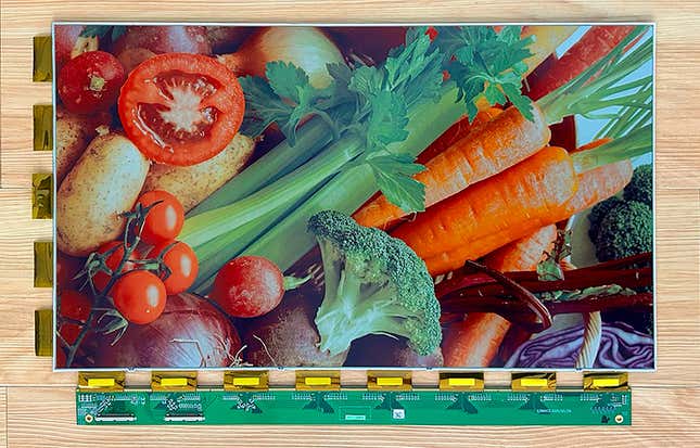 A sample of E Ink's Spectra 6 e-paper panel displaying a colorful image of fruits and vegetables.