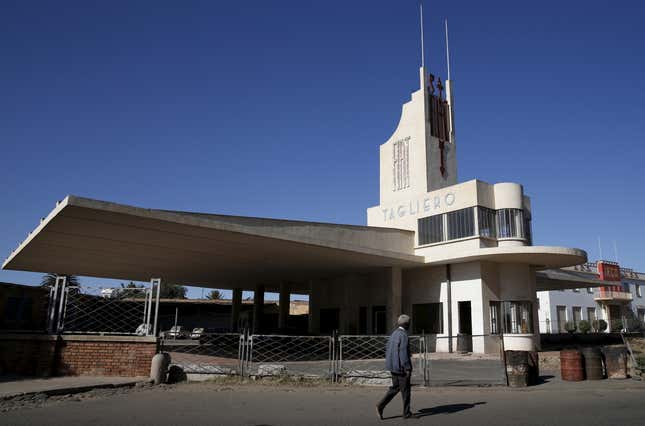 A man walks past the Fiat Tagliero building designed by the Italian architect Giuseppe Pettazzi in a futuristic style and completed in 1938.