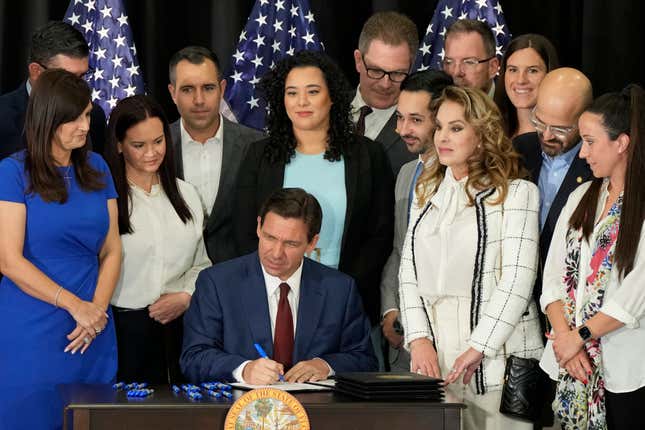 Florida Governor Ron DeSantis signs several bills related to public education and teacher pay at a press conference in Miami, Tuesday, May 9, 2023.

