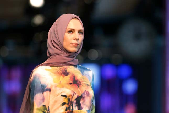 A model hits the catwalk of a fashion show during the International Modest Fashion Week, in Istanbul, Friday, May, 13, 2016. Turkeys first International Modest Fashion Week has opened in Istanbul bringing designers and models of conservative wear from around the world. The two-day event kicked off Friday with models hitting the runway at a historic train station donning a bright palette of breezy garment and kaleidoscopic headscarves. (AP Photo/Lefteris Pitarakis)