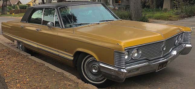 gold 1968 chrysler imperial with black sim top parked on a side street against a curb