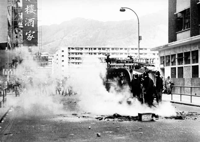 Firemen put out a rubbish blaze in street. Rioters in the San Po Kong industrial area set hundreds of street fires in an effort to slow the movement of riot patrol units in May 1967.