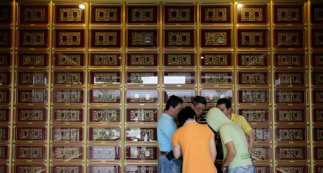 A family pays respect to their ancestors at a columbarium, where ashes are housed. (Reuters)