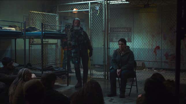 Kathleen (Melanie Lynskey) interrogates a group of "collaborators" while the heavily armed Perry (Jeffrey Pierce) stands nearby in a scene from HBO's The Last of Us.