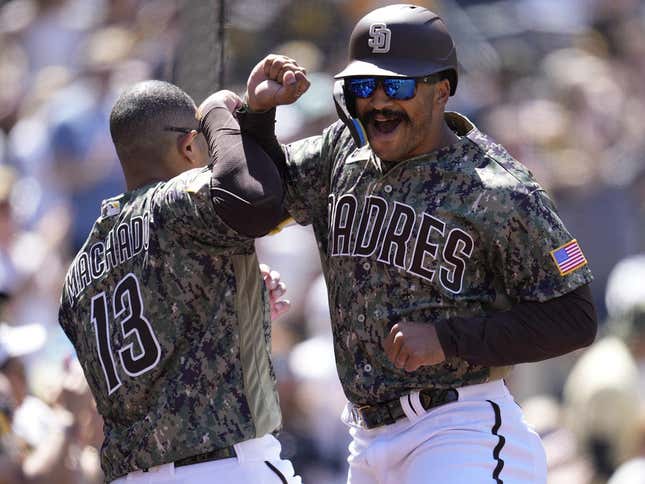 Apr 2, 2023; San Diego, California, USA;  San Diego Padres center fielder Trent Grisham (right) celebrates his home run with third baseman Manny Machado (13) against the Colorado Rockies during the first inning at Petco Park.