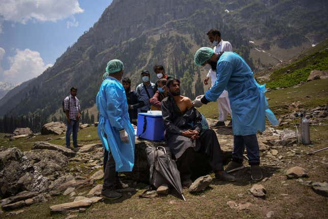 A healthcare worker administers a dose of CoviShield, a coronavirus disease vaccine, to a shepherd man during a vaccination drive in Lidderwat, located in India Kashmir's Anantnag district in June 2021.