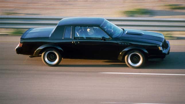 A photo of a black Buick GNX coupe driving on a highway.
