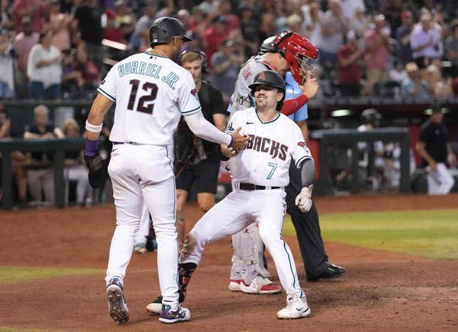 Aug 24, 2023; Phoenix, Arizona, USA; Arizona Diamondbacks center fielder Corbin Carroll (7) celebrates his two run home run with Arizona Diamondbacks left fielder Lourdes Gurriel Jr. (12) against the Cincinnati Reds during the eighth inning at Chase Field.