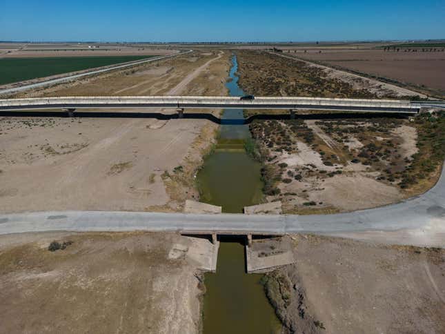 A car drives over a bridge where the canal should be full of water to supply agricultural areas in the area on April 15, 2023 in Jerez de la Frontera, Spain. 