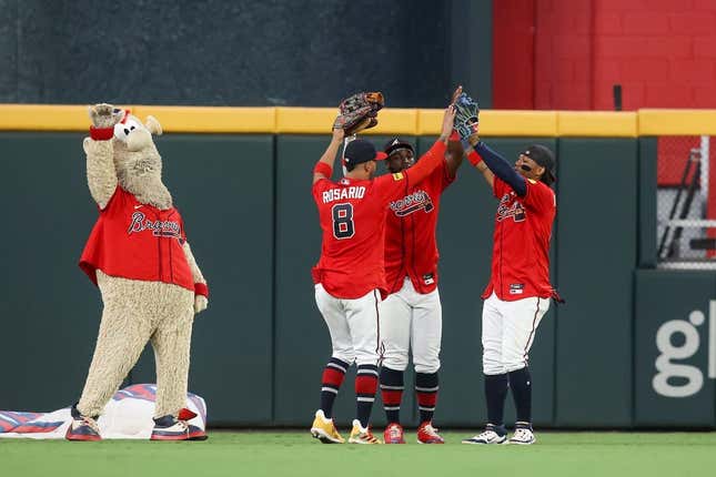 Sep 8, 2023; Atlanta, Georgia, USA; Atlanta Braves mascot Blooper and left fielder Eddie Rosario (8) and center fielder Michael Harris II (23) and right fielder Ronald Acuna Jr. (13) celebrate after a victory against the Pittsburgh Pirates at Truist Park.