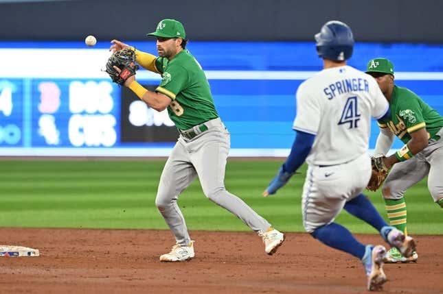 Jun 23, 2023; Toronto, Ontario, CAN;   Oakland Athletics shortstop Tyler Wade (8) loses the ball after forcing out Toronto Blue Jays right fielder George Springer (4) at second base in the third inning at Rogers Centre.