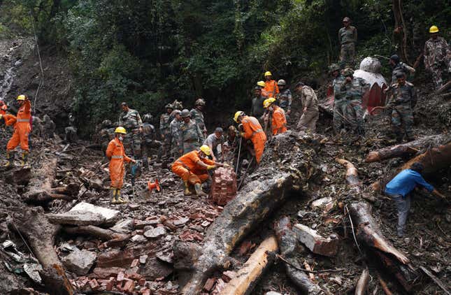 Rescue workers remove the debris as a search operation continues in the aftermath of a landslide following torrential rain in Shimla in the northern state of Himachal Pradesh, India, August 17, 2023.