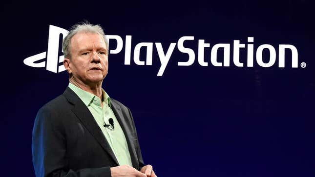 PlayStation president Jim Ryan standing in front of the company's logo. 