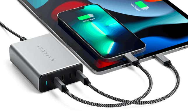 An iPhone and an iPad connected to a Satechi multi-port charger using USB-C cables.