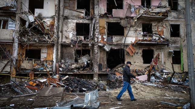 A man walks past a building damaged following a Russian rocket attack in the city of Kyiv, Ukraine on Feb. 25, 2022.