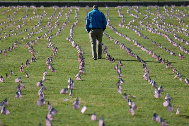  Chris Duncan, whose 75-year-old mother Constance died from COVID on her birthday, walks through a COVID Memorial Project installation of 20,000 American flags on the National Mall as the United States crosses the 200,000 lives lost in the COVID-19 pandemic on September 22, 2020, in Washington, DC.