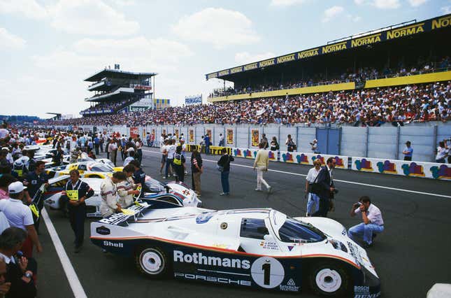 The pre-race line up of cars before the 24 Hours of Le Mans, 15th June 1985. In the foreground is a Rothmans Porsche 962C, driven by Jacky Ickx and Jochen Mass, which eventually came in 10th.