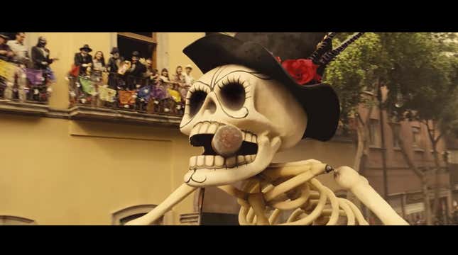A huge skull parade float is shown wearing a hat and smoking a cigar.