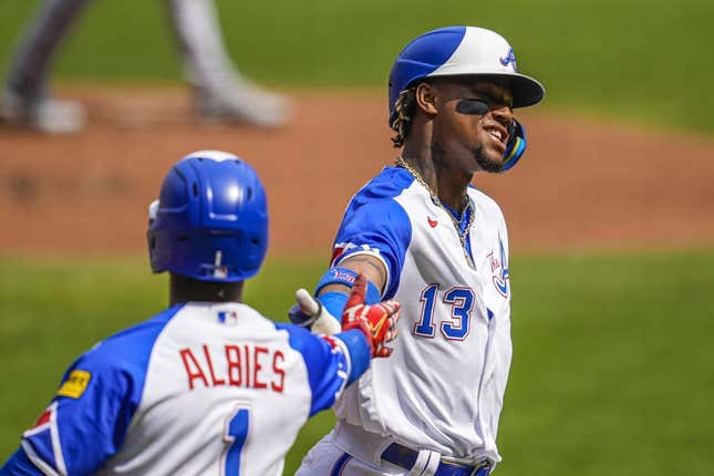 Jun 10, 2023; Cumberland, Georgia, USA; Atlanta Braves right fielder Ronald Acuna Jr. (13) reacts with second baseman Ozzie Albies (1) after scoring a run against the Washington Nationals during the first inning at Truist Park.